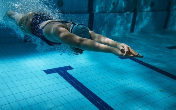 Woman swimming in pool | Jiu Jitsu Legacy
